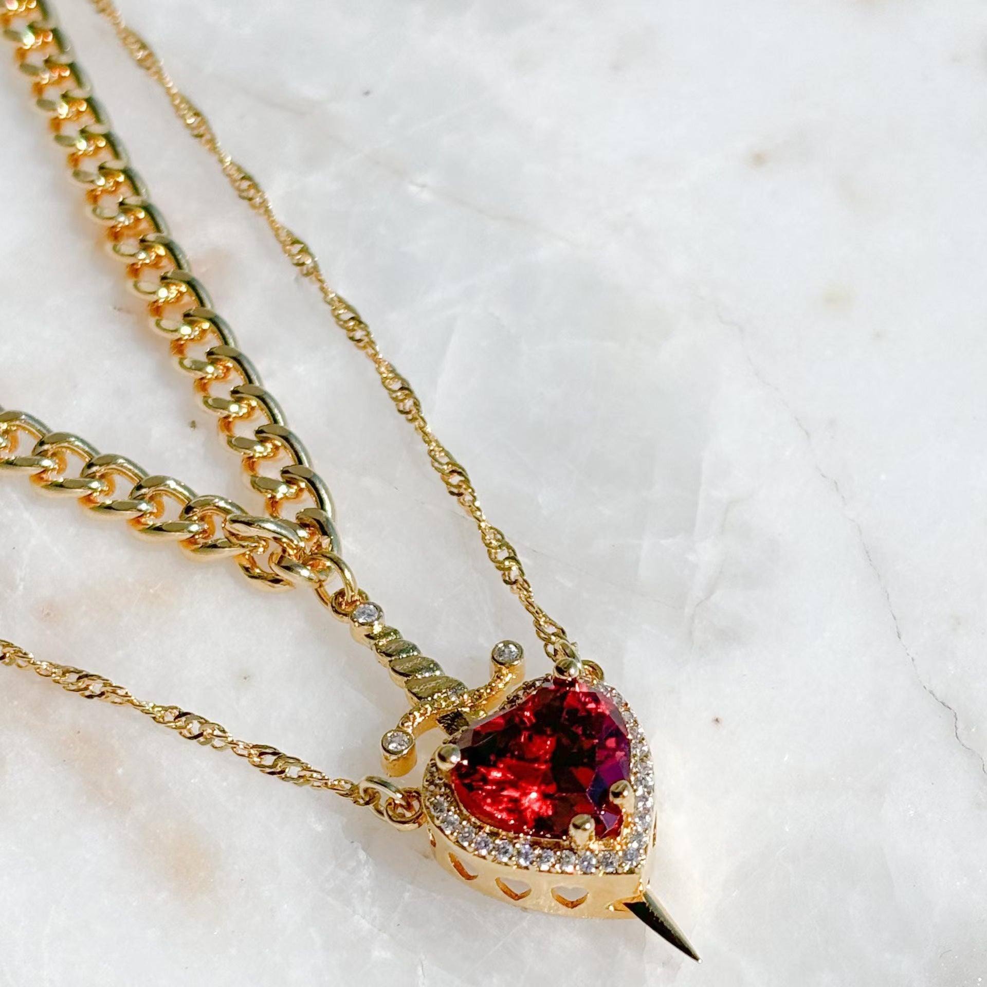 heart sword necklace, gothic jewelry, layered gold necklace, red gemstone pendant, edgy statement chain, stainless steel necklace, romantic punk style, bold fashion jewelry, valentines gift, unique love pendant  2. Product Description XL-080