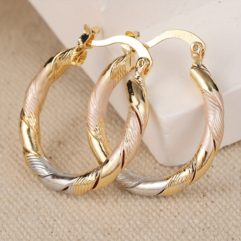twisted hoop earrings, gold hoops, pink enamel detail, vintage style earrings, minimalist jewelry, statement hoops, everyday wear, lightweight earrings, 14K gold plated, elegant accessories EH-114